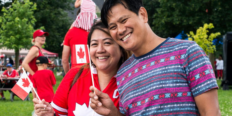 couple holding canadian flags