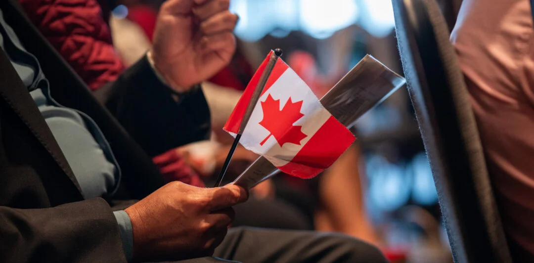canadian citizenship oath with a man holding a small canadian flag